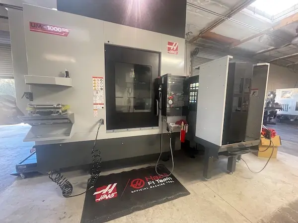 Our Haas UMC-1000SS super-speed 5-axis CNC machining center for tight tolerance component manufacturing.